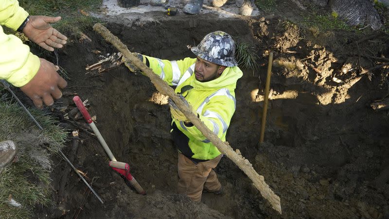 A cut lead pipe is pulled from a dig site for testing at a home in Royal Oak, Mich., on Nov. 16, 2021. The Environmental Protection is proposing a plan to replace all lead pipes in the nation’s water system over the next 10 years..