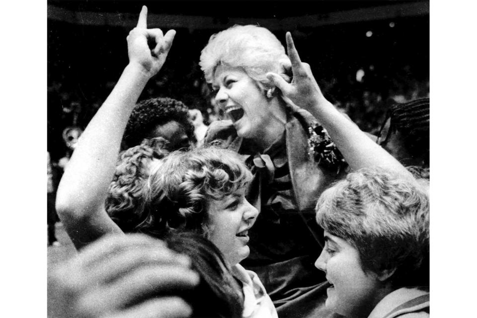 FILE - Louisiana Tech women's basketball coach Sonja Hogg is carried off the floor of McArthur Court in Eugene, Ore, following the Lady Techsters 79-59 win over Tennessee in the AIAW National Basketball Championship, March 29, 1981. (AP Photo/Harley Soltes, File)