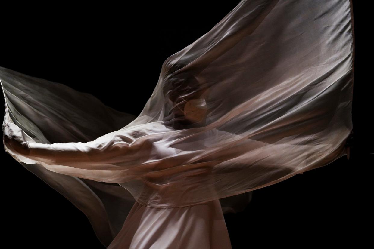 DeAnn Harper, of Gahanna, waves silk flags while performing with the Leap of Faith Dance Company during a Martin Luther King Jr. Day event at the Ohio History Center Monday.