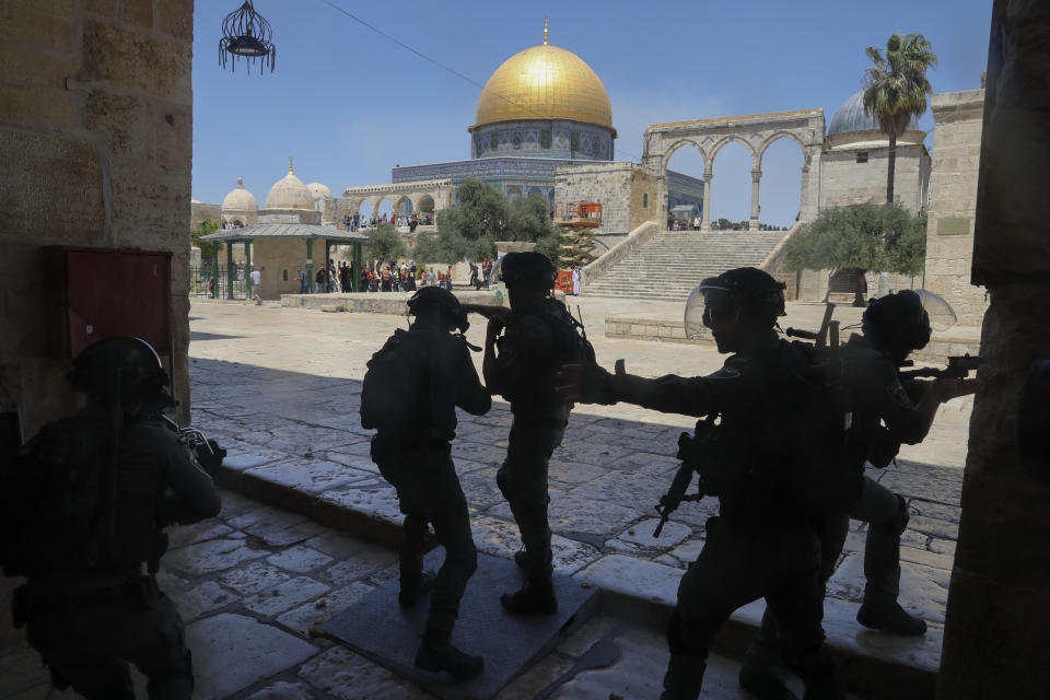 Israeli security forces take positions during clashes with Palestinians in front of the Dome of the Rock Mosque at the Al Aqsa Mosque compound in Jerusalem's Old City, Friday, June 18, 2021. (AP Photo/Mahmoud Illean)