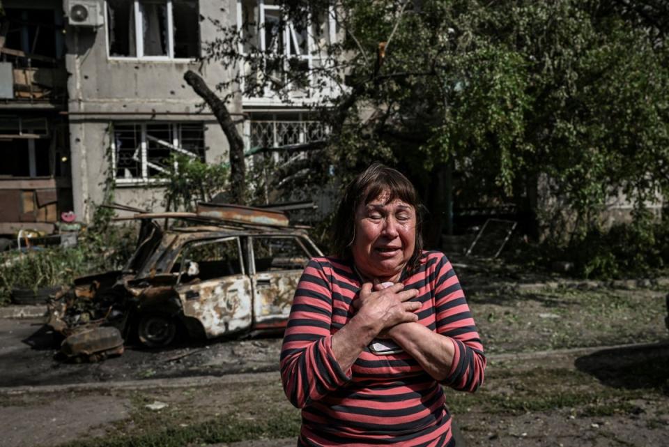 A woman reacts outside an apartment block destroyed by Russian missiles (AFP/Getty)