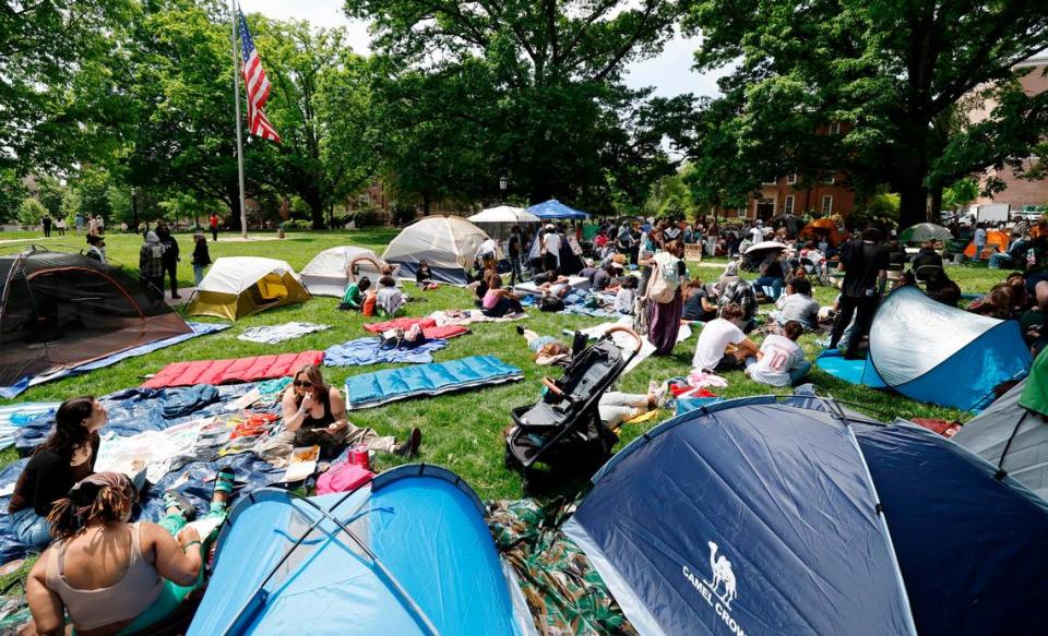 Protesters gather amongst their tents as part of a Gaza Solidarity Encampment at Polk Place on the campus of UNC-Chapel Hill on Friday afternoon, April 26, 2024.