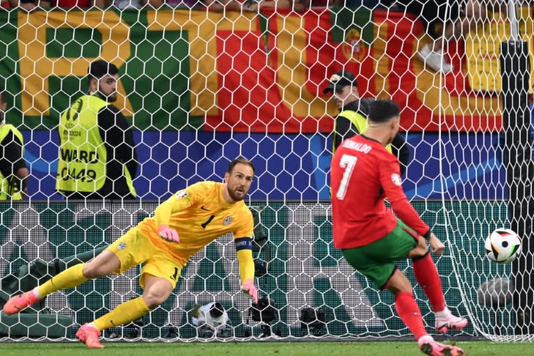 Portugal forward Cristiano Ronaldo missed a penalty in extra-time against Slovenia with <a class="link " href="https://sports.yahoo.com/soccer/players/379451/" data-i13n="sec:content-canvas;subsec:anchor_text;elm:context_link" data-ylk="slk:Jan Oblak;sec:content-canvas;subsec:anchor_text;elm:context_link;itc:0">Jan Oblak</a> denying him brilliantly (Kirill KUDRYAVTSEV)