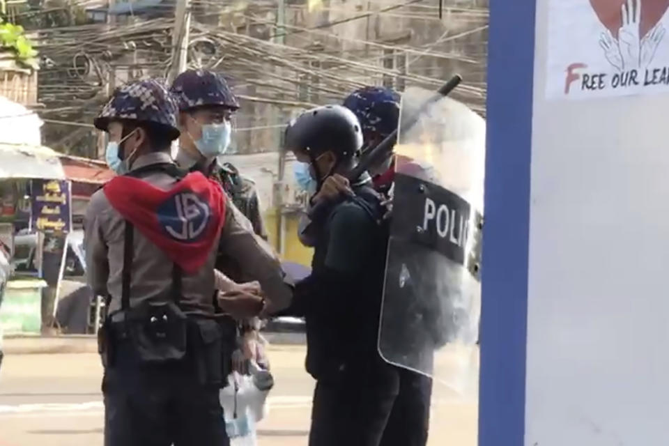 FILE - In this file image made from video taken on Feb. 27, 2021, Associated Press journalist Thein Zaw is arrested by police in Yangon, Myanmar. The plentiful and unsettling imagery, filmed by participants on the ground and uploaded, is bringing protests and crackdowns to millions of handheld devices almost immediately. Zaw taken into custody in a chokehold by authorities while doing his job captured on video and widely shared. (AP Photo/File)