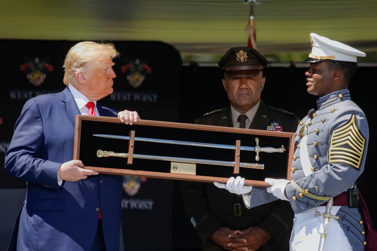 Donald Trump is offered a class gift after speaking to United States Military Academy graduating cadets during commencement ceremonies at West Point, New York: AP