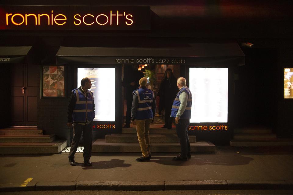 COVID inspectors peer through pub doors tlooking for lock-ins as the country begins its 10pm curfew for bars and restaurants - measures which could last up to six months (Dan Barker/Twitter)