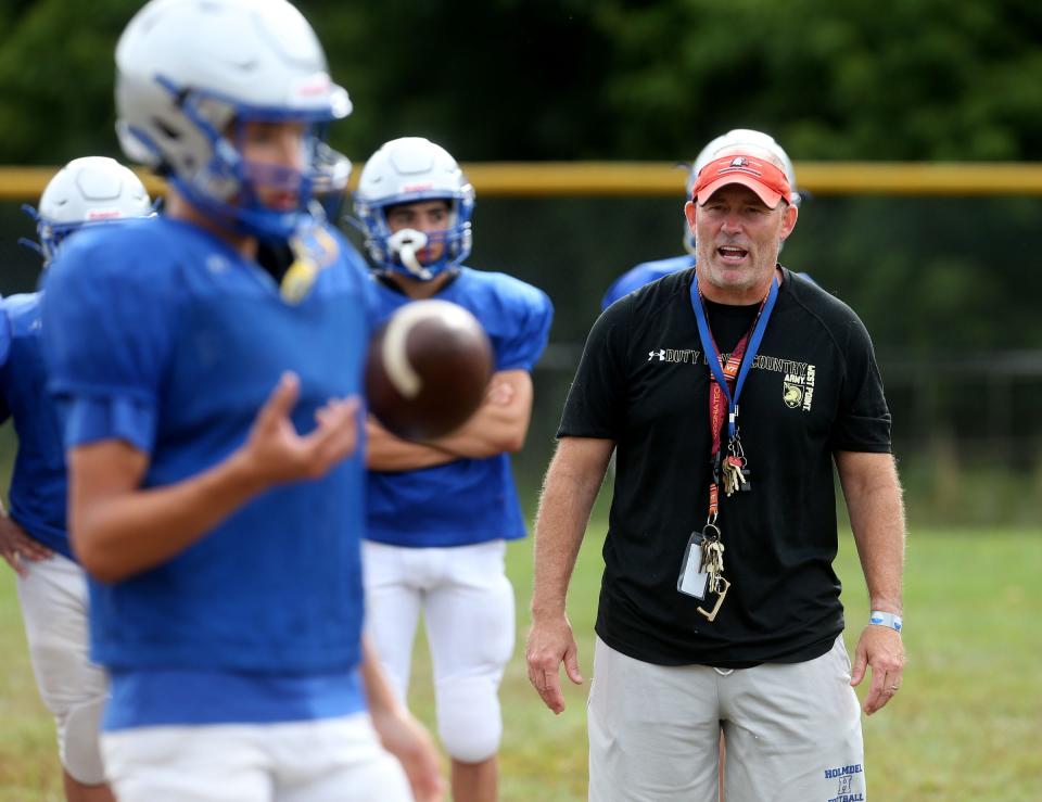 Holmdel High School football head coach Jeff Rainess runs drills with his players Monday morning, August 22, 2022.  