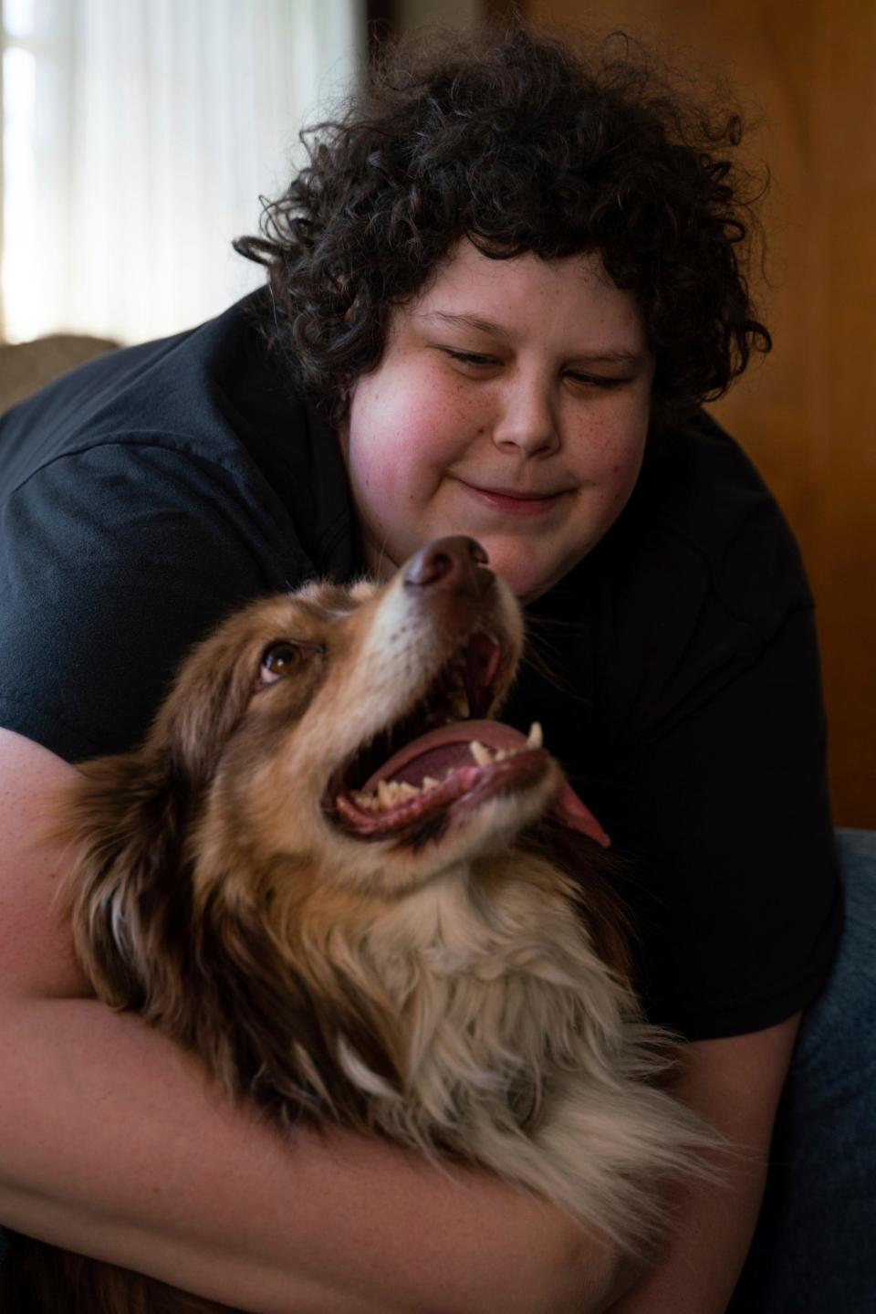 Joe Alice, 30, sits with his dog named Mark at his home in Southgate on Friday, April 7, 2023. "I don't even have any friends except my dog. It's been hard," said Alice, who enjoys public speaking, learning about autism, and considers himself a huge Western fan. "If I'm stressed out or having a panic attack I'll pet him, hug him, or talk to him and he'll calm me down. Even when he just smiles. He opens up his mouth and it looks like a smile and it just melts me and makes me feel so much better."