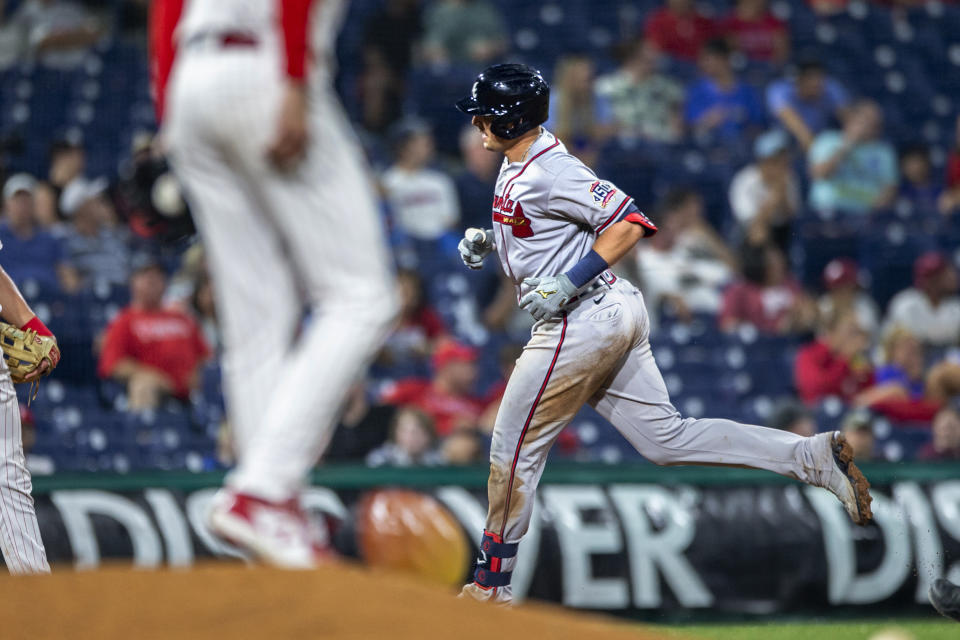 Atlanta Braves' Austin Riley runs past Philadelphia Phillies relief pitcher Connor Brogdon after hitting a home run during the eighth inning of a baseball game Tuesday, June 8, 2021, in Philadelphia. (AP Photo/Laurence Kesterson)