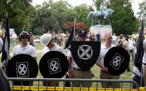 White supremacists gather under a statue of Robert E. Lee during a rally in Charlottesville, Virginia - Credit: Reuters