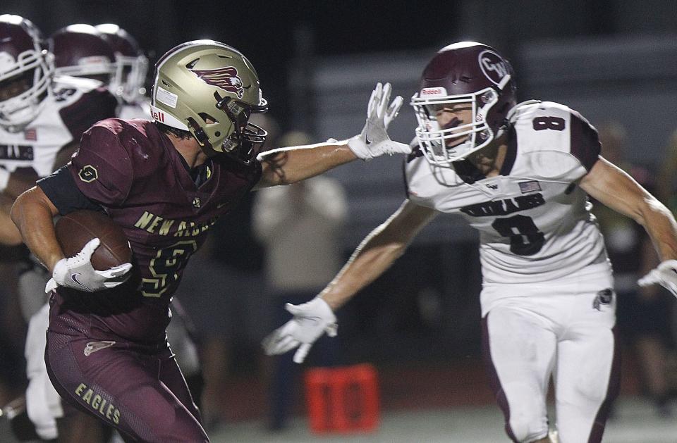 New Albany's Dylan Rosser holds off Canal Winchester's Braylon Beckwith as he runs into the end zone during their game at New Albany on August 26.  The Eagles won 45-13.