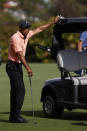 Tiger Woods watches play from his golf cart during the first round of the PNC Championship golf tournament Saturday, Dec. 18, 2021, in Orlando, Fla. (AP Photo/Scott Audette)