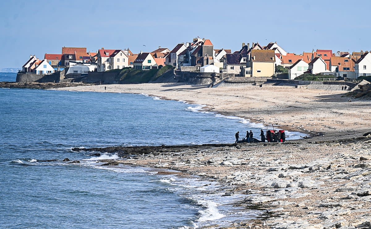 French gendarmes use a tractor to pull the damaged migrants’ boat near the beach of Ambleteuse, northern France (AFP/Getty)