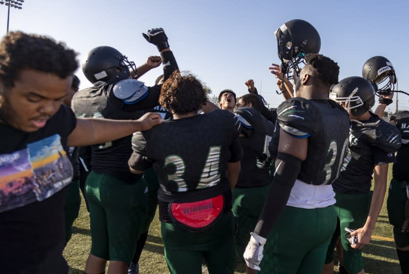 LOS ANGELES, CA - APRIL 9, 2021: Hawkins football team rallies for a cheer after losing to Manual Arts 27-0 during their first game of the season on April 9, 2021 in Los Angeles, California. Gina Ferazzi / Los Angeles Times)