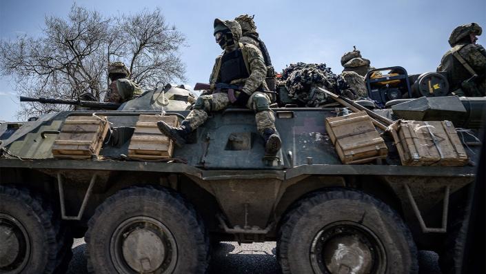 Ukrainian soldiers ride on an APC. The US is sending another $1 billion in weapons to the country.