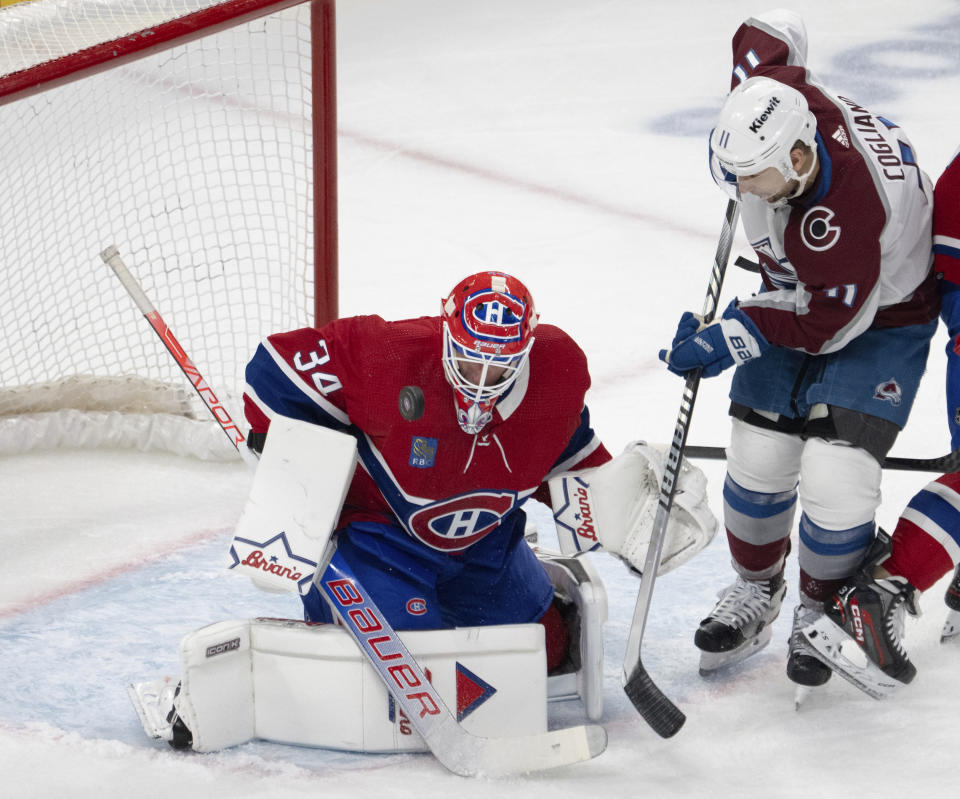 Colorado Avalanche center Andrew Cogliano (11) is stopped by Montreal Canadiens goaltender Jake Allen (34) during the second period of an NHL hockey game Monday, Jan. 15, 2024, in Montreal. (Ryan Remiorz/The Canadian Press via AP)