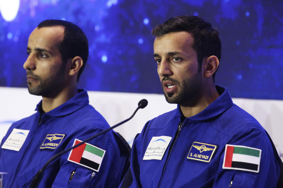 Emirati astronaut Sultan al-Neyadi, right, speaks to journalists with astronaut Hazza al-Mansoori, in Dubai, United Arab Emirates, Monday, Feb. 25, 2019. The UAE said on Monday it will send either astronaut al-Mansoori or al-Neyadi to the International Space Station on Sept. 25 aboard a Russian Soyuz rocket. The UAE has a fledgling space program with big ambitions. (AP Photo/Jon Gambrell)