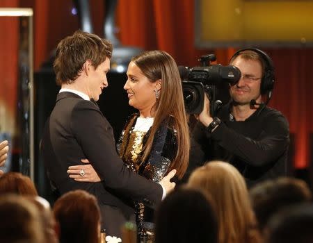 Alicia Vikander is congratulated by Eddie Redmayne as she accepts the award for Outstanding Performance by a Female Actor in a Supporting Role for her role in "The Danish Girl" at the 22nd Screen Actors Guild Awards in Los Angeles, California January 30, 2016. REUTERS/Lucy Nicholson