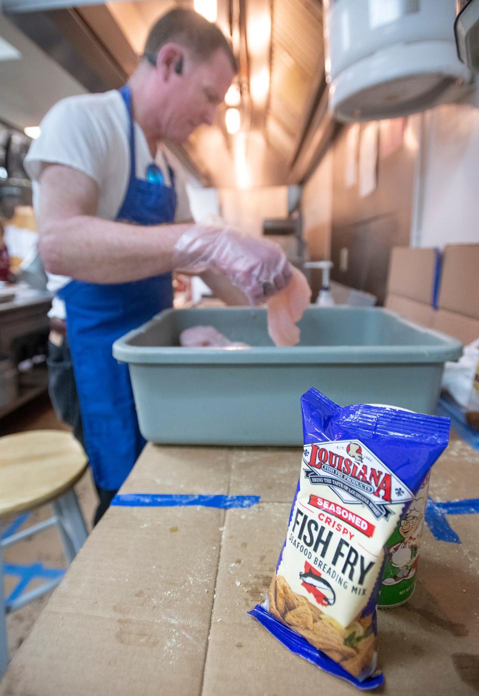 Danny Agnew batters fish during the Knights of Columbus' weekly Lenten Fish Fry at the Cathedral of the Sacred Heart in Pensacola on Friday, March 4, 2022.