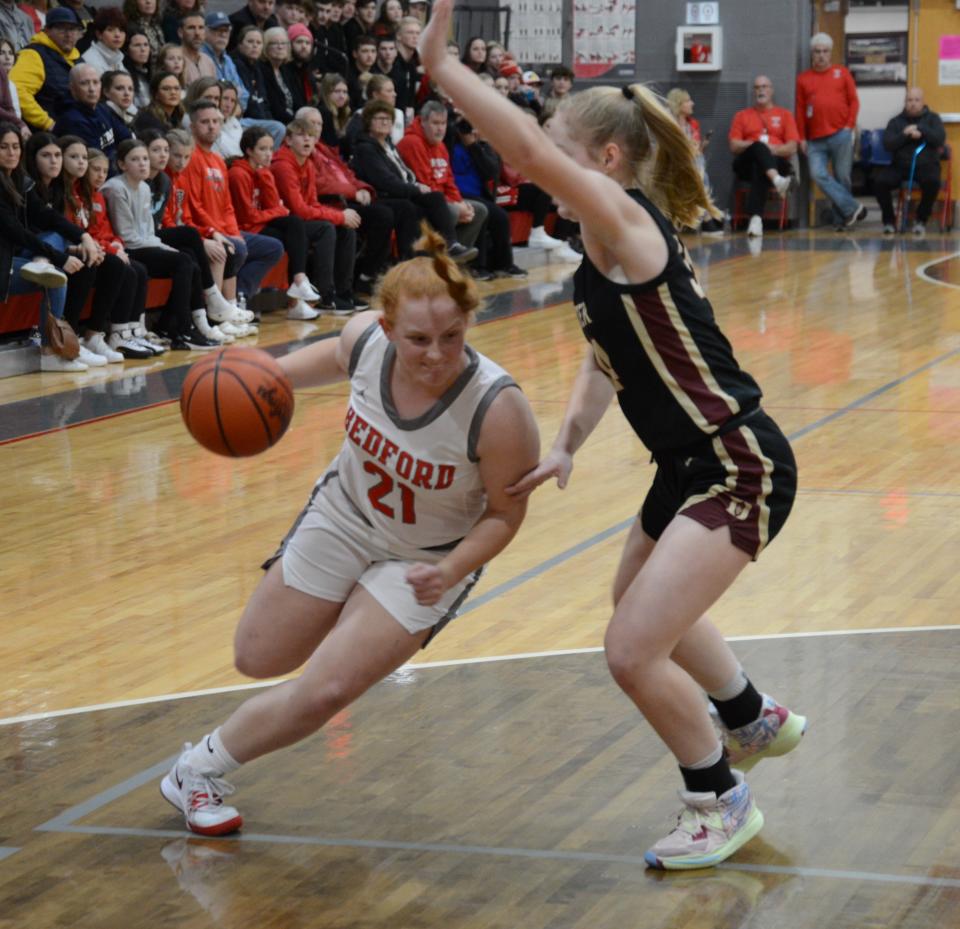 Aubrey Hensley of Bedford drives against Dexter's Heidi Fuchs Friday night.