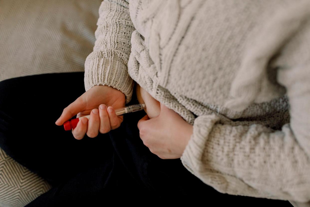 <span>A woman injects herself in the abdomen as part of the IVF process.</span><span>Photograph: Maskot/Getty Images</span>