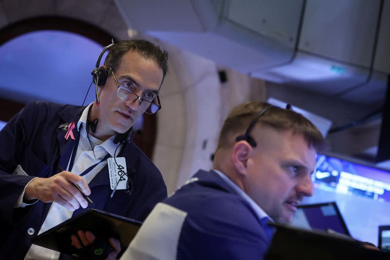 Traders work on the floor of the NYSE in New York