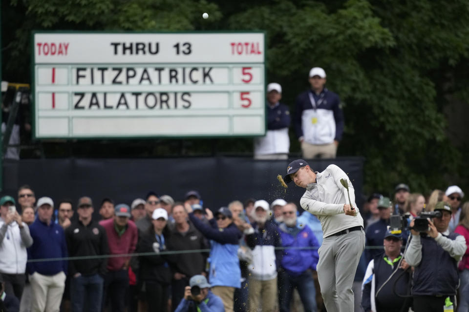 Matthew Fitzpatrick, of England, hits on the 14th hole during the final round of the U.S. Open golf tournament at The Country Club, Sunday, June 19, 2022, in Brookline, Mass. (AP Photo/Charlie Riedel)