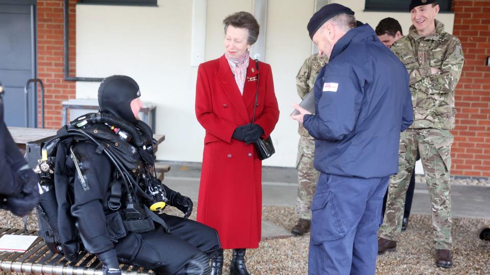 Princess Anne speaking to a underwater explosive ordinance disposal operator in diving suit