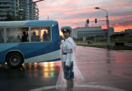 <p>A traffic police officer directs vehicles at a street junction during sunset in Pyongyang, North Korea, Aug. 25, 2016. (Photo: Dita Alangkara/AP)</p>