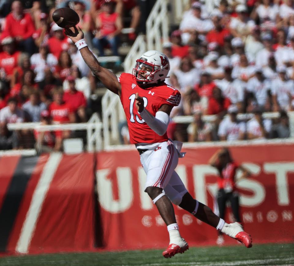 Utah Utes quarterback Nate Johnson (wearing red) throws 