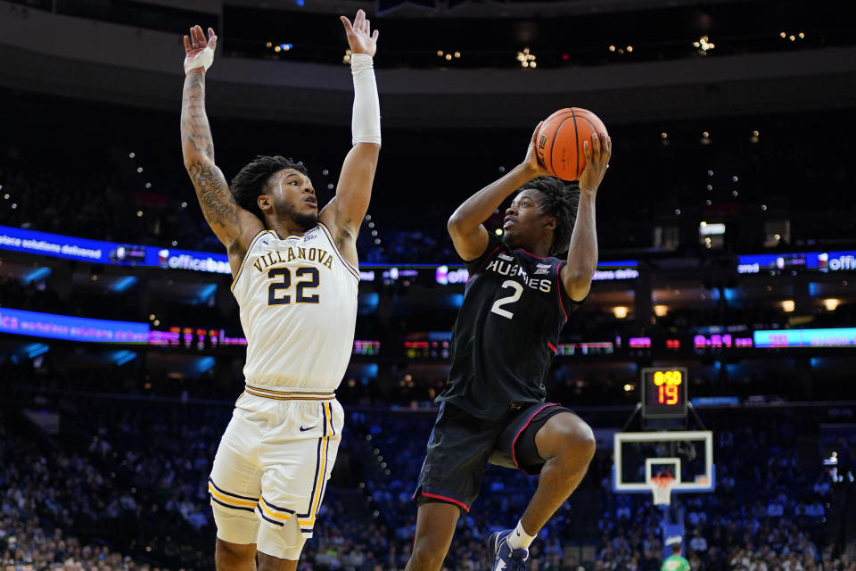 UConn's Tristen Newton, right, goes up for a shot against Villanova's Cam Whitmore during the second half of an NCAA college basketball game, Saturday, March 4, 2023, in Philadelphia. (AP Photo/Matt Slocum)