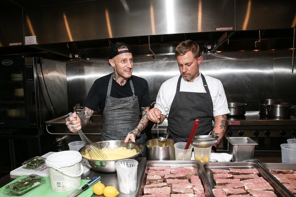 Michael Voltaggio and Bryan Voltaggio cooking steaks
