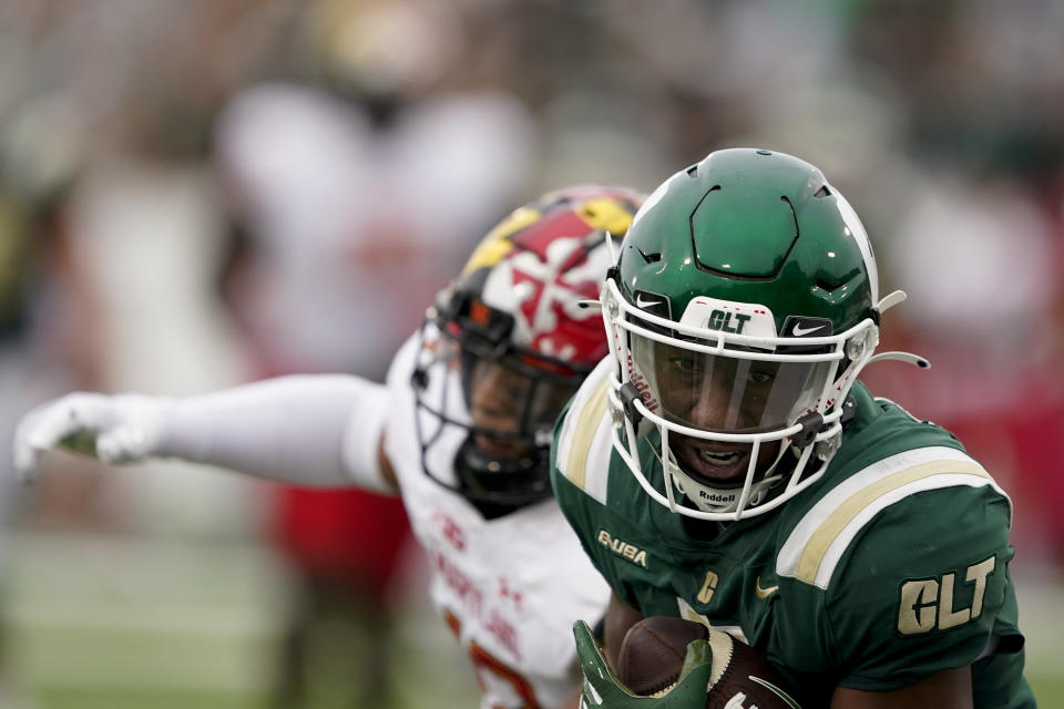 Charlotte wide receiver Victor Tucker catches a touchdown pass in front of Maryland defensive back Dante Trader Jr. during the first half of an NCAA college football game on Saturday, Sept. 10, 2022, in Charlotte, N.C. (AP Photo/Chris Carlson)