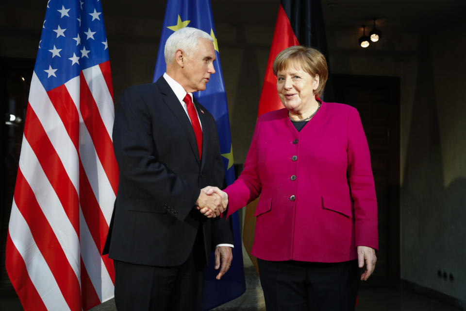 German Chancellor Angela Merkel, right, welcomes United States Vice President Mike Pence, left, for a bilateral meeting during the Munich Security Conference in Munich, Germany, Saturday, Feb. 16, 2019. (AP Photo/Matthias Schrader)