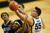 Iowa center Luka Garza (55) fights for a rebound with Southern University guard Ahsante Shivers during the second half of an NCAA college basketball game, Friday, Nov. 27, 2020, in Iowa City, Iowa. Iowa won 103-76. (AP Photo/Charlie Neibergall)