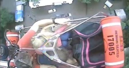 An aircrew from Coast Guard Air Station New Orleans rescues three people from a rooftop due to flooding in Baton Rouge, Louisiana, U.S., in this still image from video taken on August 13, 2016. Coast Guard Air Station New Orleans/Handout via REUTERS