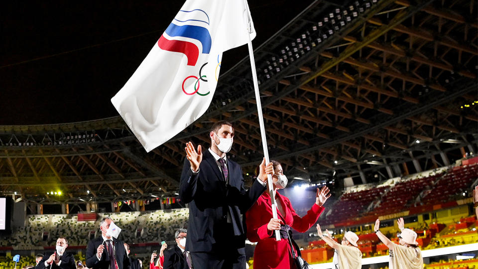 Flag bearers Sofya Velikaya and Maxim Mikhaylov of Team ROC lead their team in during the Opening Ceremony of the Tokyo 2020 Olympic Games.