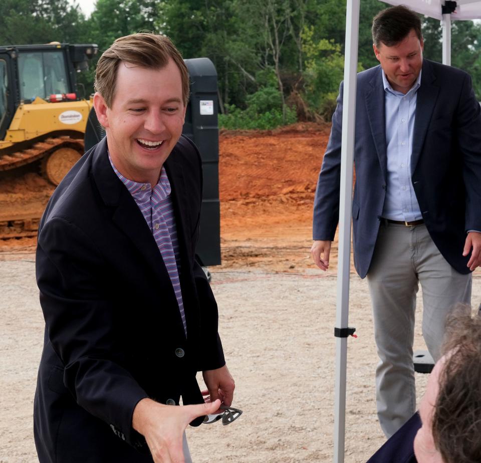 Local governments broke ground on the McWrightÕs Ferry Rd. extension Friday, July 21, 2023. Kyle South greets local lawmakers before the ceremony.