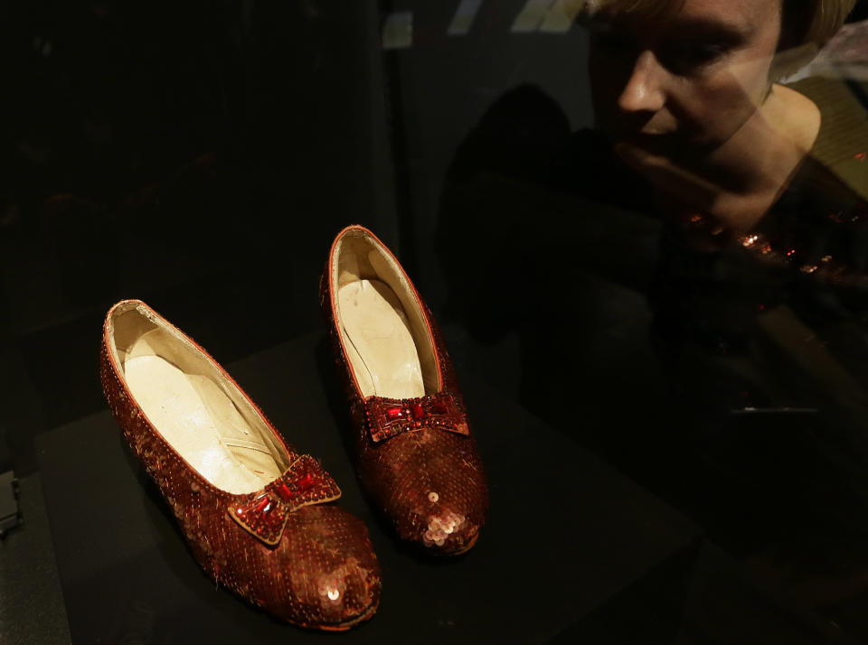 One of the four original pairs of 'Ruby Slippers' worn by Judy Garland playing Dorothy from the iconic 1939 Wizard of Oz film on view at the Hollywood Costume exhibition at the Victoria and Albert Museum in London, Tuesday, Oct. 16, 2012. The slippers are on loan from the Smithsonian National Museum of American History and are on display till Nov. 18, when they must return to the US, so that they are back in time for the Thanksgiving national holiday. The slippers were designed by MGM studios chief costume designer Adrian, who designed most of the costumes for the Wizard of Oz film.  The show at the Victoria and Albert Museum showcases more than one hundred movie costumes from a century of film-making. The exhibition opens to the public on Oct. 20, 2012 and run till 27 Jan. 2013.(AP Photo/Alastair Grant)