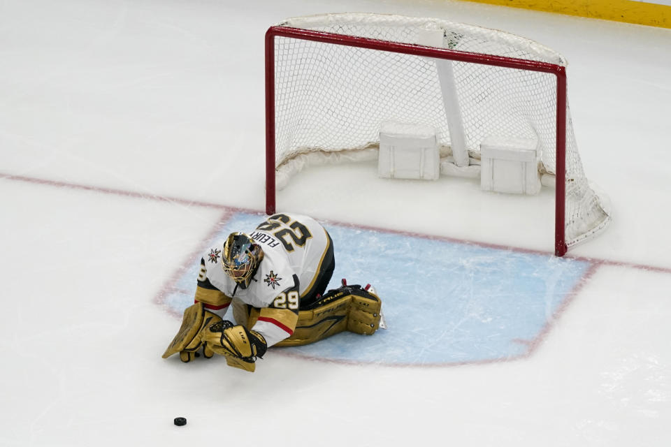 Vegas Golden Knights goaltender Marc-Andre Fleury stops a puck with his gloves after losing his stick during the third period of an NHL hockey game against the St. Louis Blues Wednesday, April 7, 2021, in St. Louis. (AP Photo/Jeff Roberson)