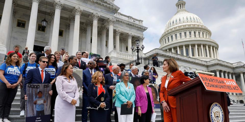 House Speaker Nancy Pelosi leads a rally celebrating the passage of gun safety legislation as protesters swarm the court just yards away on June 24, 2022.