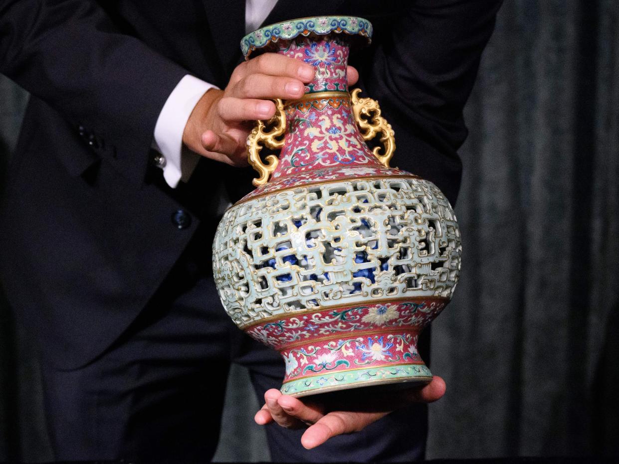 Nicolas Chow, Chairman of Sotheby's Asia, holding the Harry Garner Reticulated Vase.