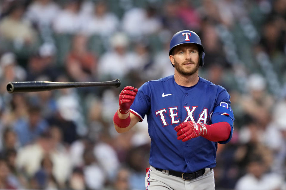 Texas Rangers designated hitter Robbie Grossman flips his bat after a base on balls during the seventh inning of a baseball game against the Detroit Tigers, Tuesday, May 30, 2023, in Detroit. (AP Photo/Carlos Osorio)