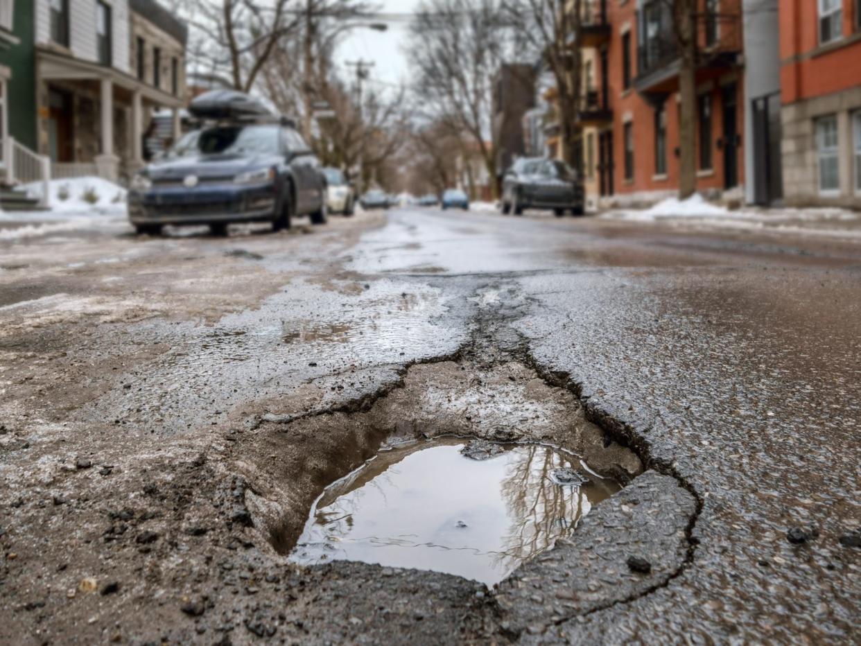 Large deep pothole in Montreal street, Canada.
