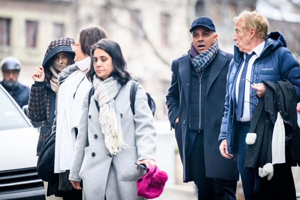 Indian-Swiss billionaire family members Namrata Hinduja (L) and Ajay Hinduja (2ndR) arrive at the Geneva's courthouse with their lawyers Yael Hayat (C) and Robert Assael (R) at the opening day of their trial for human trafficking on January 15, 2024. The family has been accused of having employed several foreign servants without work authorization or residence permit, of having remunerated them in a terse manner by making them work without day off while retaining their passports and preventing them from leaving home. (Photo by GABRIEL MONNET / AFP) (Photo by GABRIEL MONNET/AFP via Getty Images)