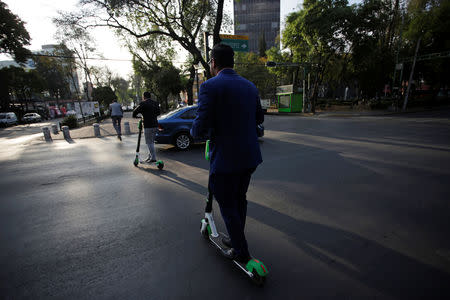 People use electric scooters in a neighbourhood in Mexico City, Mexico January 10, 2019. REUTERS/Daniel Becerril