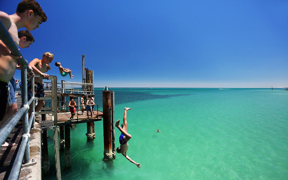 Teens will no doubt be heading down to Glenelg for some jetty jumping when the heatwave kicks in. Image: Getty