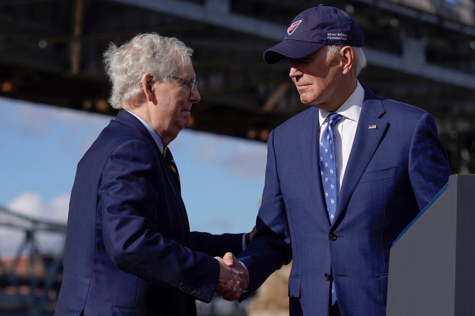 President Joe Biden shakes hands with Senate Minority Leader Mitch McConnell of Ky., after speaking about his infrastructure agenda under the Clay Wade Bailey Bridge, Wednesday, Jan. 4, 2023, in Covington, Kentucky.  (AP Photo/Patrick Semansky)