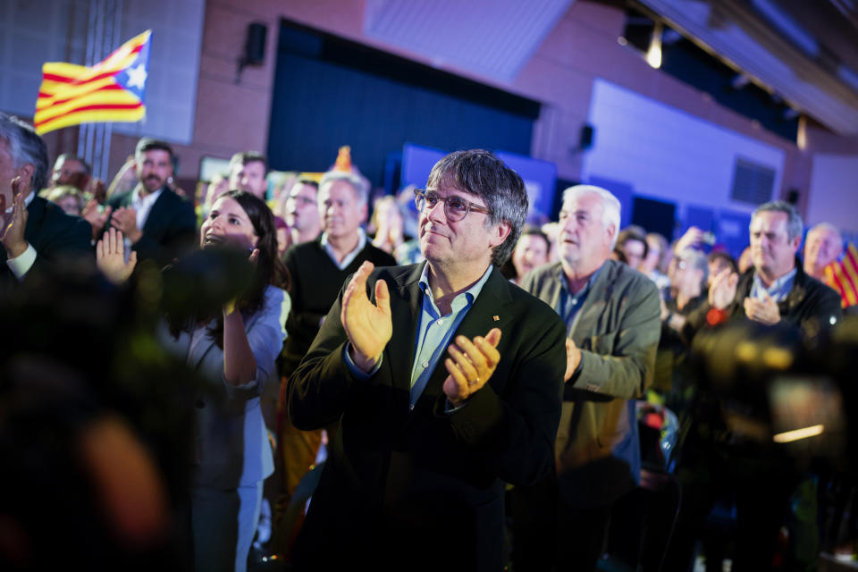 Former regional president Carles Puigdemont applauds during a campaign rally in Argelers, France, Wednesday, May 8, 2024. Carles Puigdemont, Catalonia's fugitive former leader, stares confidently out the backseat window of a car, the sun illuminating his gaze in a campaign poster for Sunday's critical elections in the northeastern Spanish region. Some nearly 6 million Catalans are called to cast ballots in regional elections on Sunday that will surely have reverberations in Spain's national politics. (AP Photo/Joan Mateu)