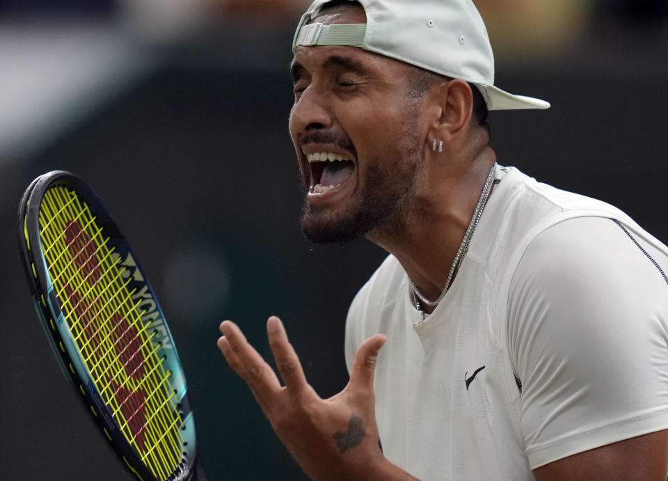 Australia's Nick Kyrgios reacts during his third round men's singles match against Greece's Stefanos Tsitsipas on day six of the Wimbledon tennis championships in London, Saturday, July 2, 2022. (AP Photo/Kirsty Wigglesworth)